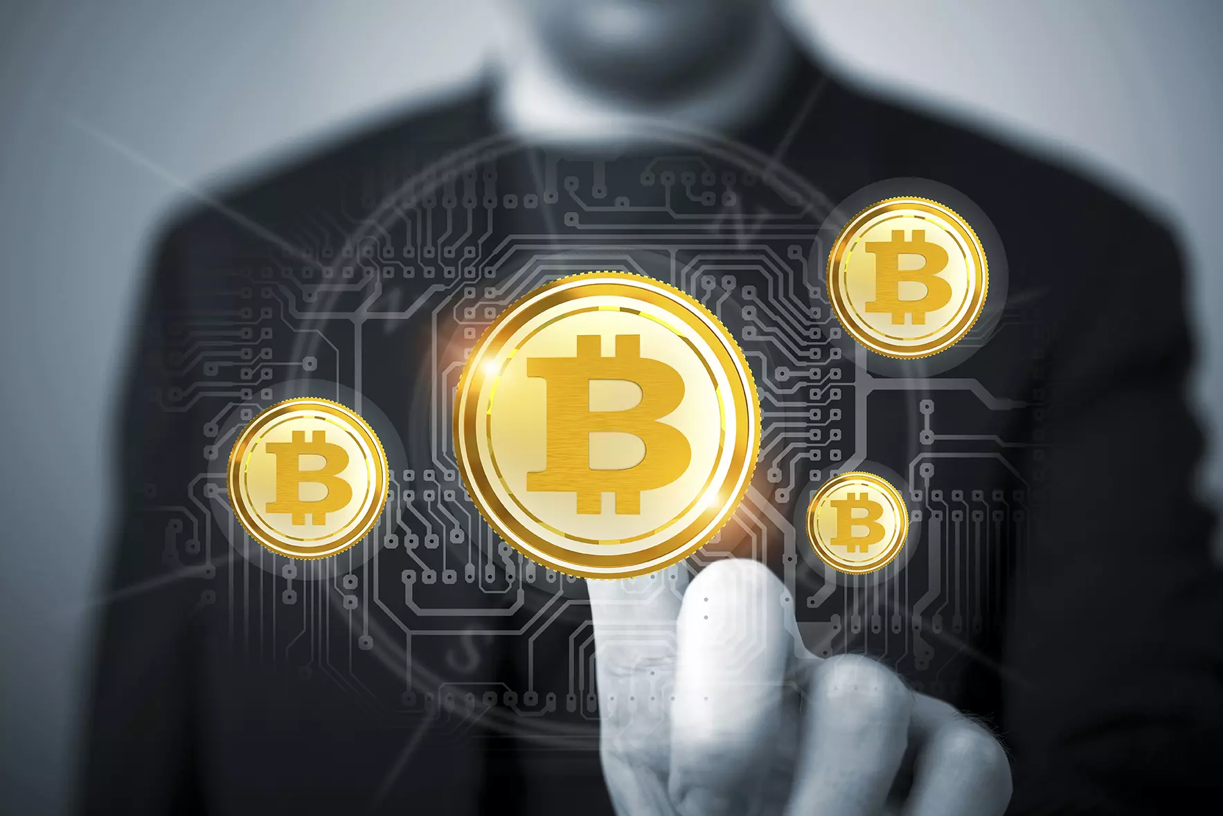 Hombre de fondo tocando monedas digitales de bitcoin representando a la bitcoin que alcanza valor récord.