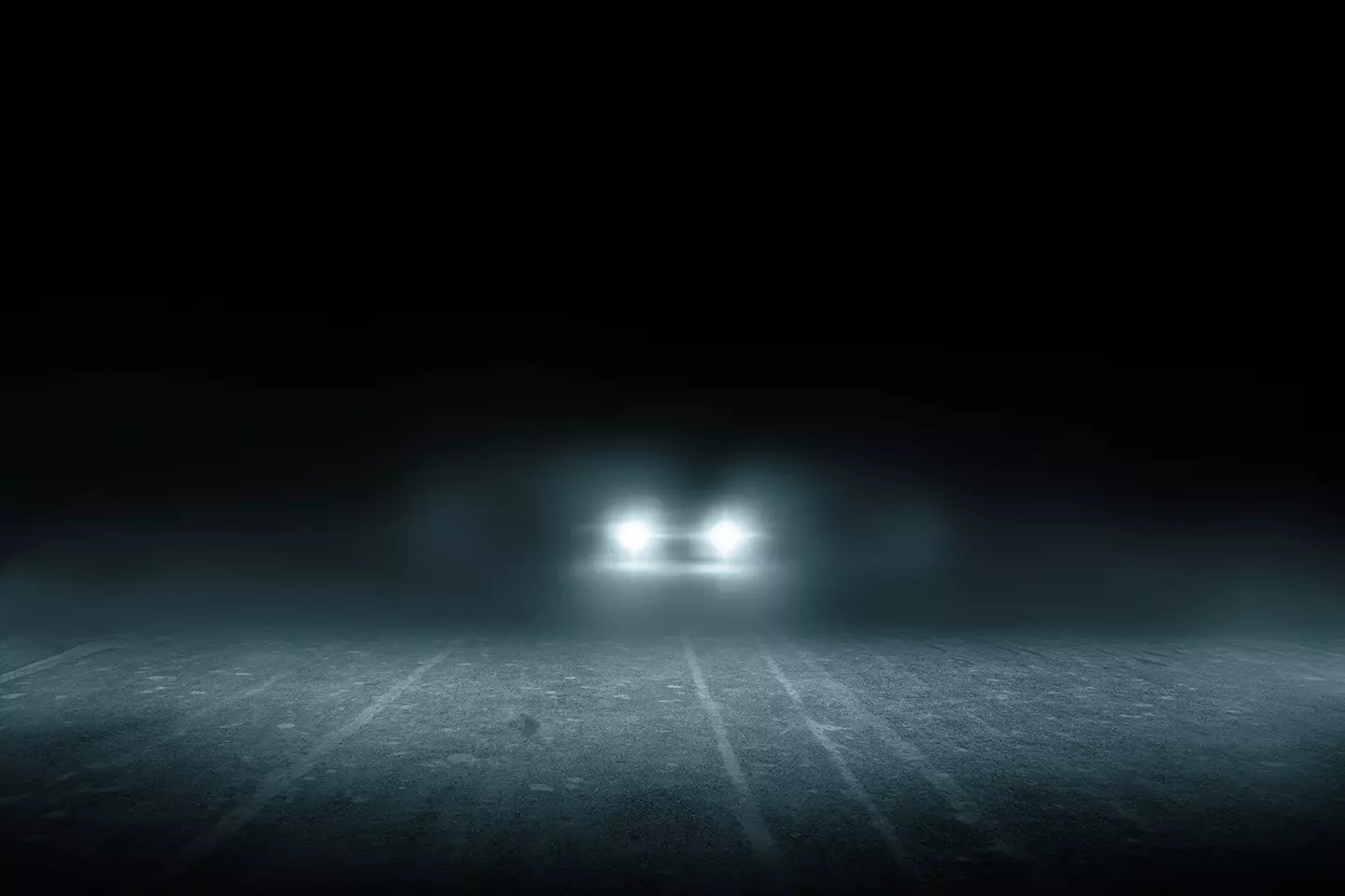 Faros de un auto encendidos en la oscuridad representando el auto con faros inteligentes que presentó Mercedes.