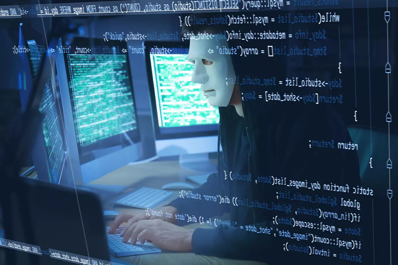 Hacker con máscara blanca, frente a computadoras realizando ciberataque masivo a telefónicas de todo el mundo.