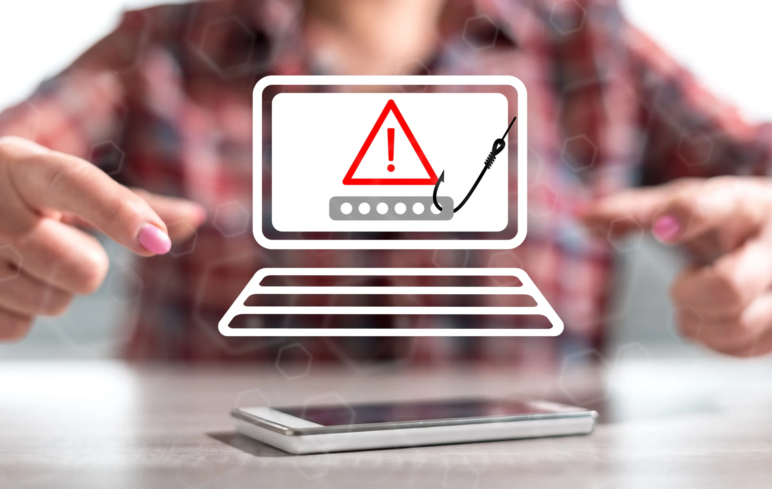 Advertencia de phishing en pantalla de laptop con ícono de alerta y anzuelo, representando riesgos de robo de credenciales y ataques de ingeniería social.